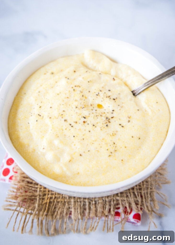 creamy polenta in a bowl with a spoon in it
