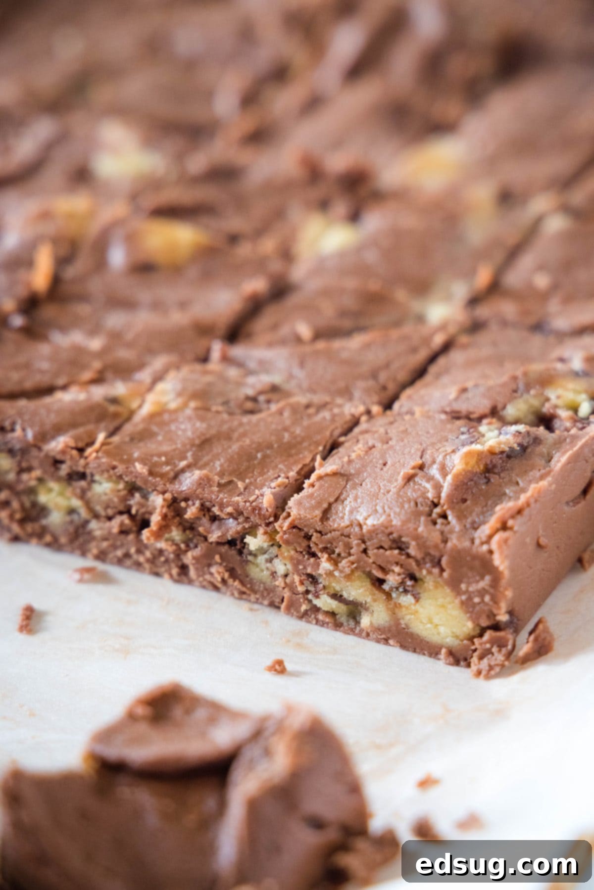 Cookie Dough Dream Fudge 6 Close-up of perfectly cut cookie dough fudge squares on a wooden cutting board