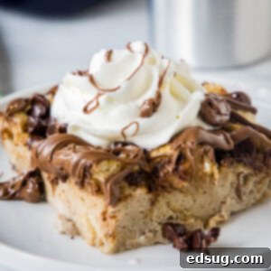 close up chocolate french toast bake served on a white plate with whipped cream