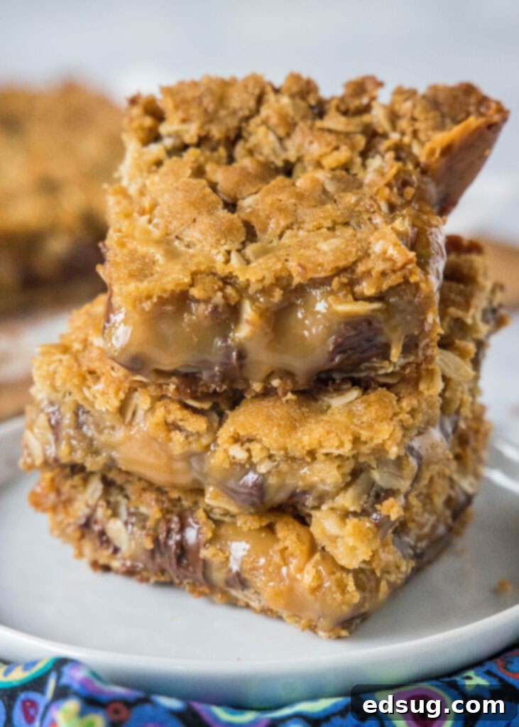 Chewy Caramel Bars 2 Stacked Caramelitas on a white plate, showcasing gooey caramel and chocolate layers