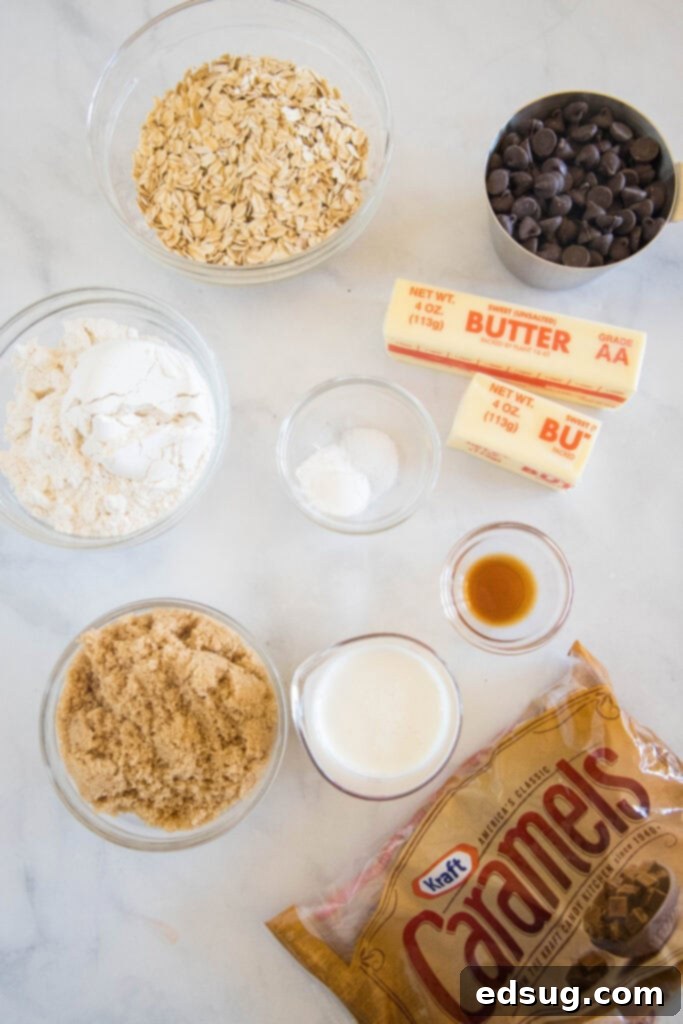 Chewy Caramel Bars 3 Various ingredients for Caramelitas laid out on a surface, including butter, sugar, oats, and unwrapped caramels