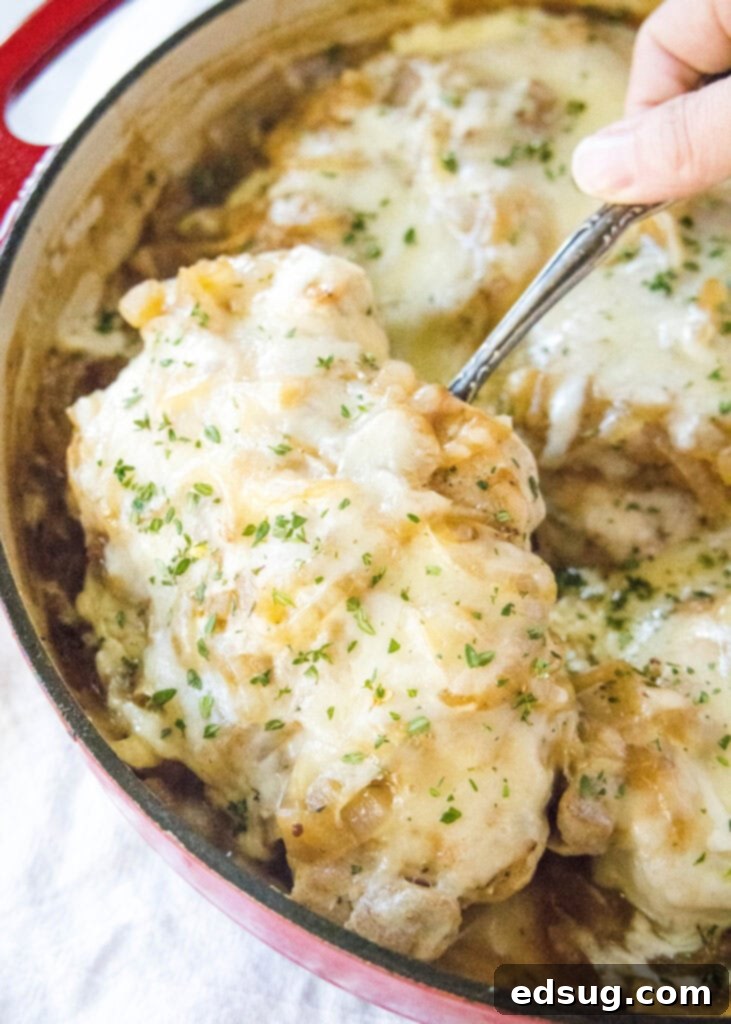 Caramelized French Onion Pork Chops 5 scooping a French onion pork chop out of the pan with a spatula