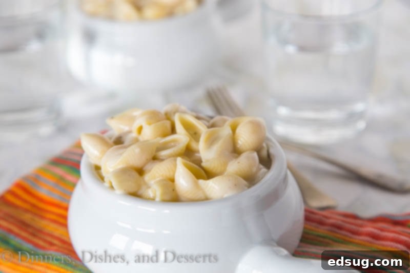 Close-up shot of the creamy cheese sauce being stirred in a saucepan.