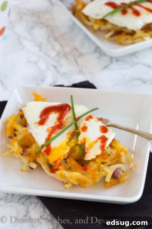 Crispy Bacon Cheese Hash Brown Waffles 2 Crispy hash brown waffle with bacon and cheese on a plate, ready to be enjoyed for breakfast or brunch.