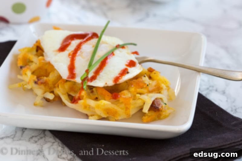 Crispy Bacon Cheese Hash Brown Waffles 3 Close-up of a hash brown waffle topped with fresh chives, ready for a fried egg.