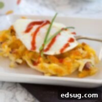 Bacon & Cheese Hash Brown Waffles - Make breakfast for dinner with these hash brown waffles that are crispy on the outside, filled with cheddar cheese and bacon! Top with a fried egg and hot sauce for breakfast perfection!