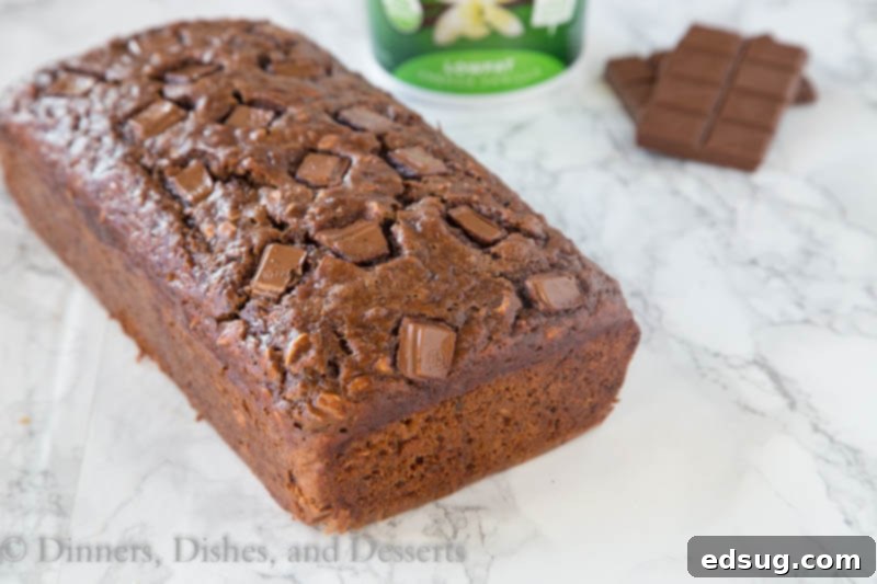 Irresistible Chocolate Chip Oatmeal Banana Bread 3 chocolate oatmeal banana bread on a wooden board, sliced to show texture