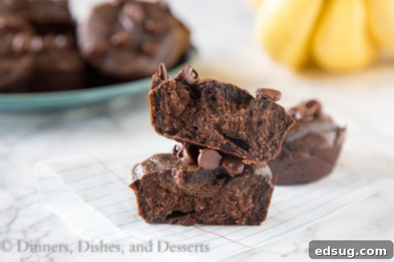 Effortless Chocolate Banana Oatmeal Muffins 3 A muffin cut in half sitting on the table
