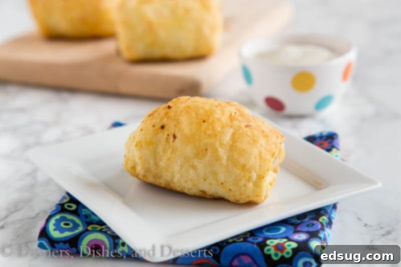 Zesty Sausage Swirls 3 All ingredients for spicy sausage rolls laid out: thawed puff pastry, raw breakfast sausage, cream cheese, shredded pepper jack, and canned diced green chiles