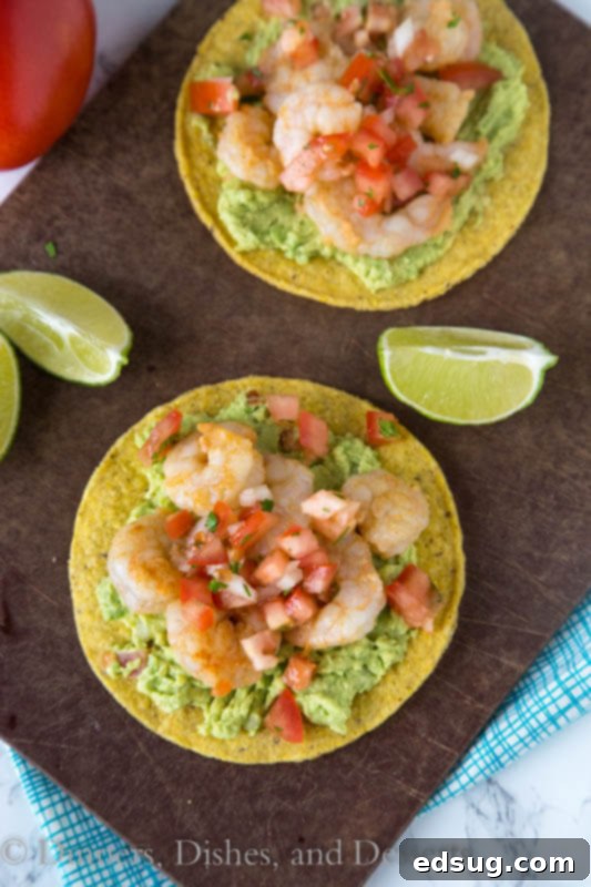 Zesty Shrimp and Avocado Tostadas 4 shrimp tostadas with lime wedges and cilantro