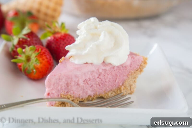 Dreamy Strawberry Milkshake Pie 3 Top view of a beautifully garnished strawberry milkshake pie with fresh whipped cream and berries