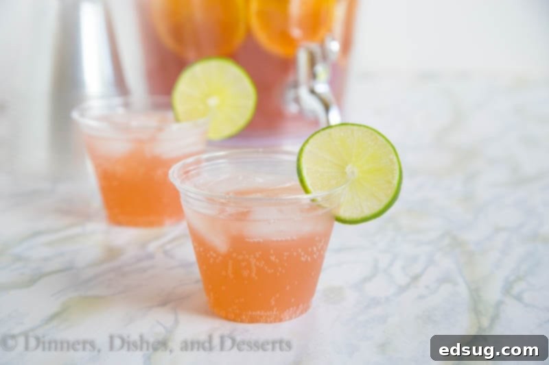 The Party Starter 3 Close-up of sparkling party punch with orange and lime slices, showcasing its refreshing appeal for any event.