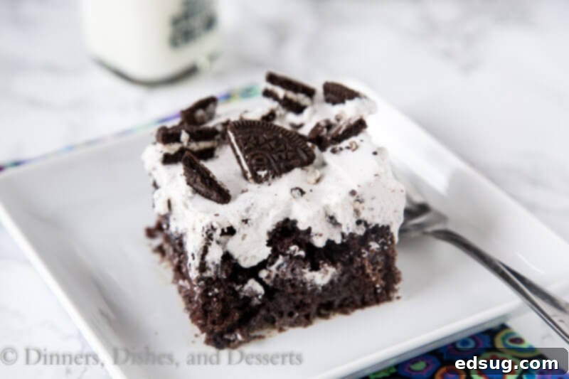 Close-up of a full Oreo Poke Cake with generous crushed Oreo cookies on top.