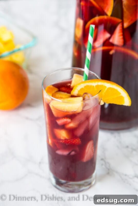 Easy Red Wine Sangria in a glass, garnished with fresh fruit, perfect for summer.