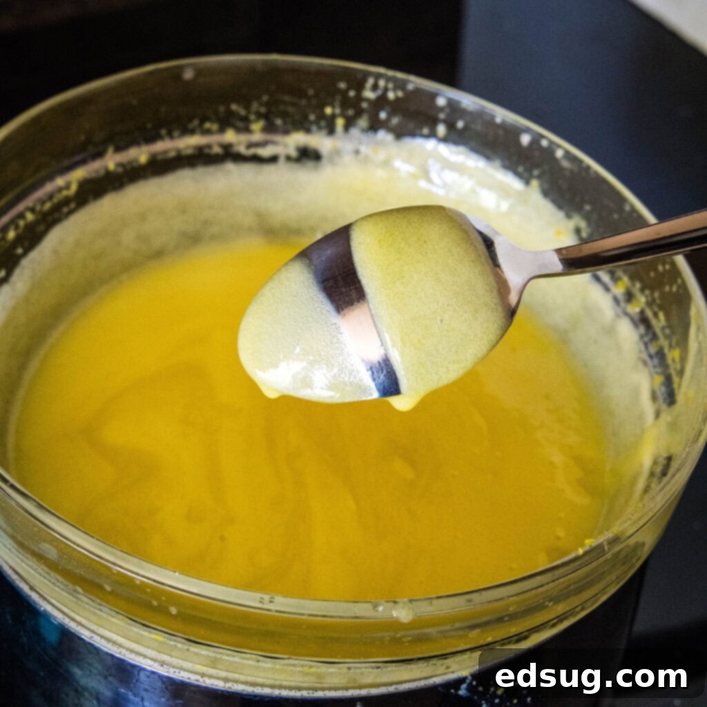 Zesty Lemon Cloud 5 thick lemon mousse coating the back of a spoon with a clear finger swipe