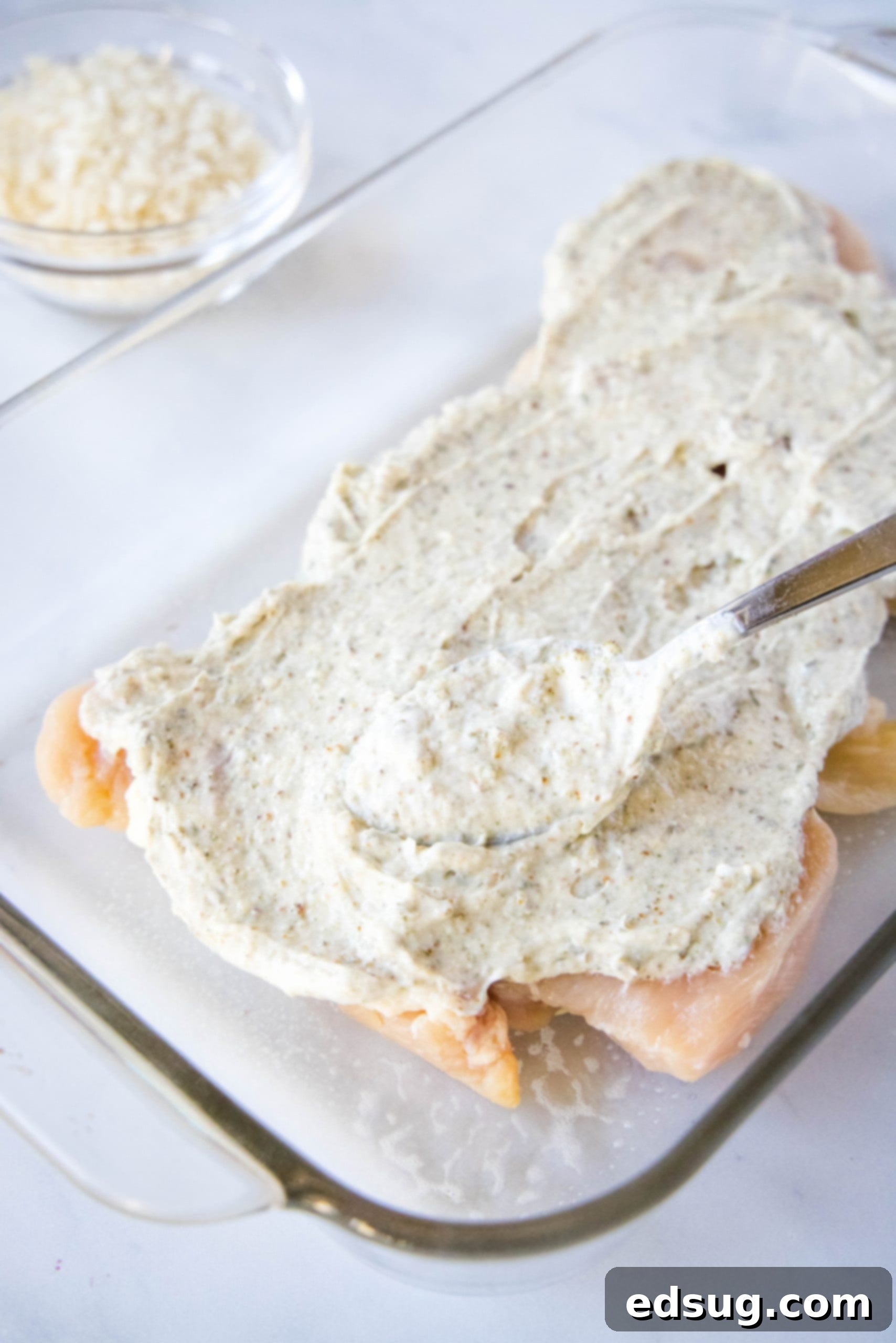 spreading ranch on chicken breasts