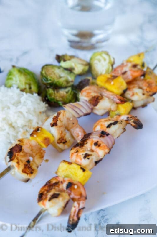 Teriyaki Grilled Shrimp Skewers 2 Grilled teriyaki shrimp kebabs on a plate, ready to be served