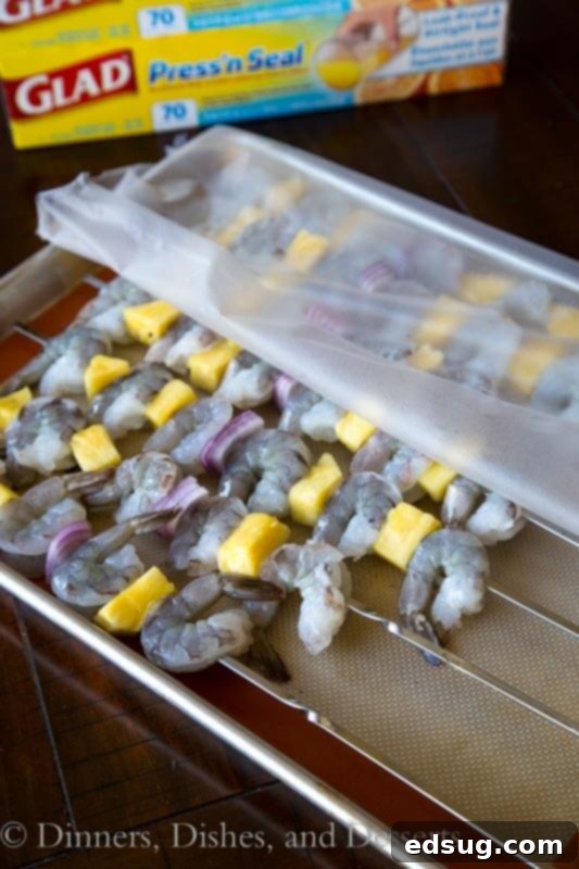 Teriyaki Grilled Shrimp Skewers 4 Ingredients for grilled teriyaki shrimp kebabs laid out in a pan