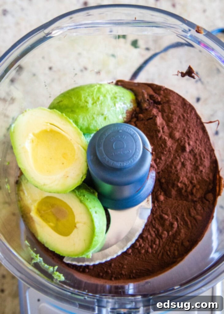 Velvet Chocolate Indulgence 3 Close-up shot of the avocado chocolate mousse blending smoothly in a food processor, showcasing its rich, dark brown color and creamy texture.