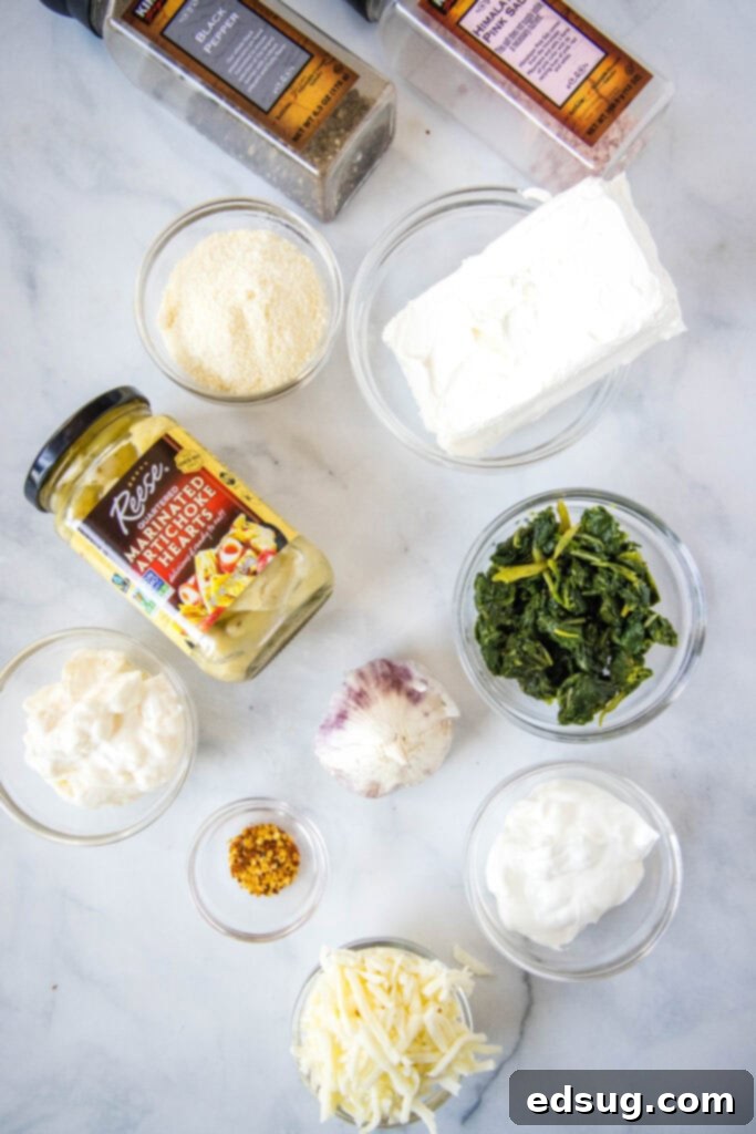 Creamy Spinach Artichoke Dip 3 spinach artichoke dip ingredients laid out for preparation