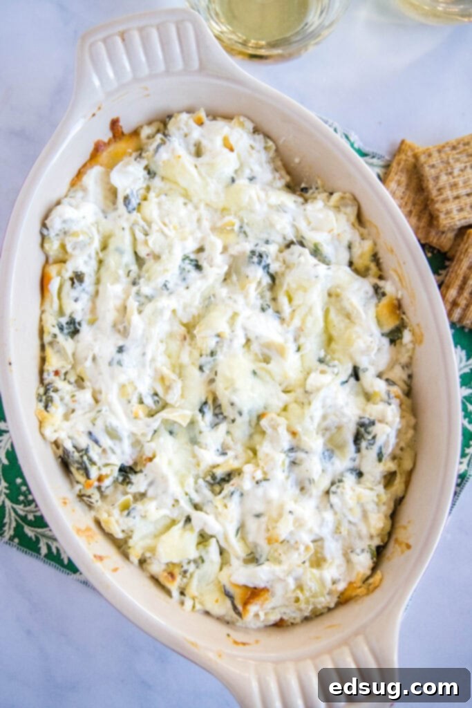 Creamy Spinach Artichoke Dip 5 baked spinach and artichoke dip bubbling in a baking dish
