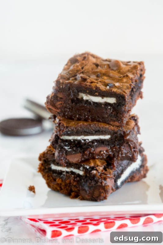 Freshly baked homemade Oreo brownies, showing the fudgy texture and cookie layer. Close-up of a pan of fudgy homemade oreo brownies
