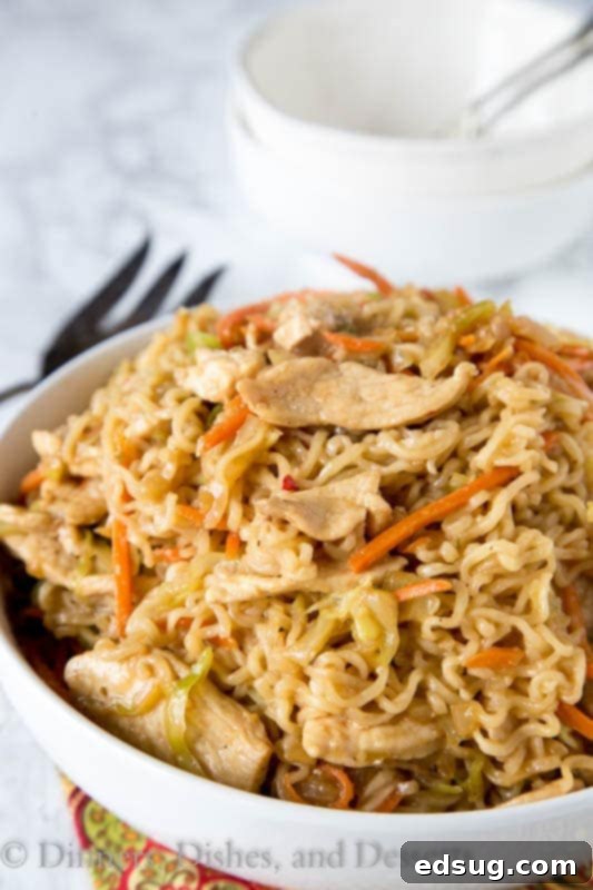Ultimate Chicken Chow Mein 2 A bowl of food on a plate, with Chicken and Noodle