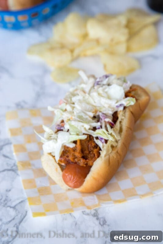 Loaded BBQ Pulled Pork Dogs 2 barbecue pulled pork hot dogs on a plate