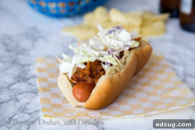 Loaded BBQ Pulled Pork Dogs 3 barbecue pulled pork hot dogs on a plate with coleslaw