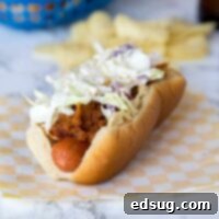 Loaded BBQ Pulled Pork Dogs 6 barbecue pulled pork hot dogs on a plate