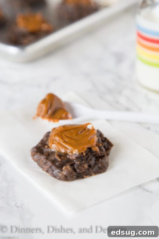 A stack of Dulce de Leche No Bake Cookies with a generous drizzle of dulce de leche on top.