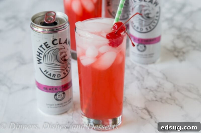 black cherry limeade served in a glass on a table, ready for a party