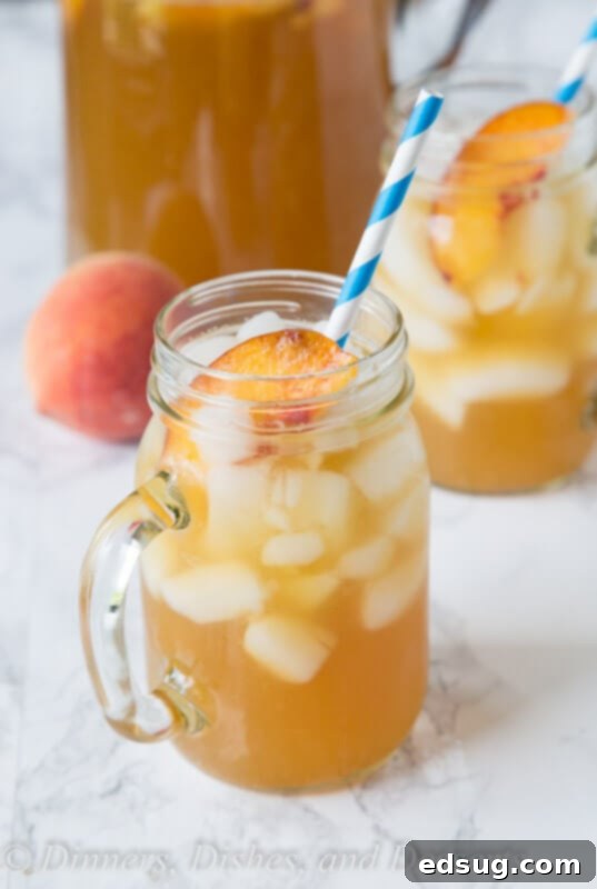 Refreshing Peach Tea Punch 2 A glass of vibrant peach tea punch, garnished and ready to enjoy.