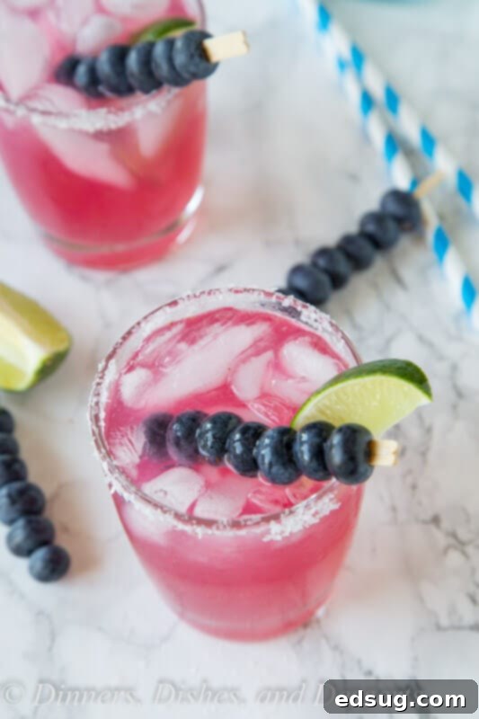 Blueberry Bliss Margaritas 4 Another view of a blueberry margarita, highlighting the vibrant color and fresh ingredients.