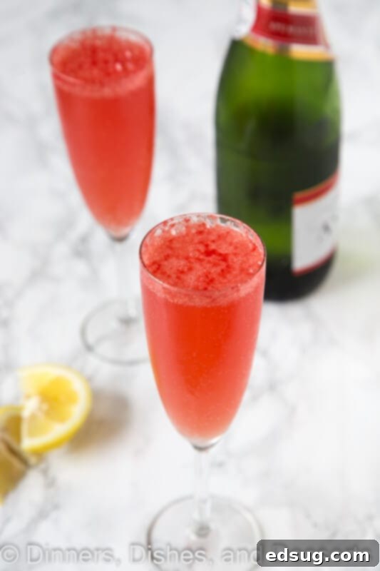 Watermelon bellini cocktail served in a tall glass, showing the vibrant pink color and refreshing appearance