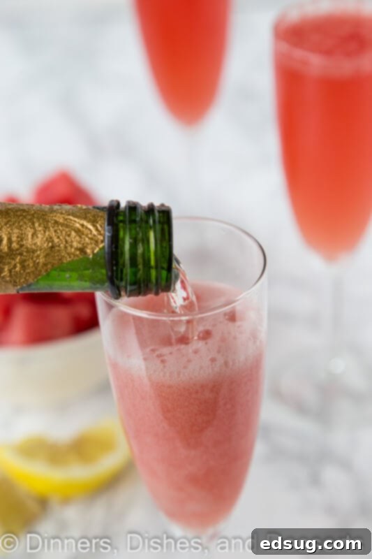 Three watermelon bellinis in elegant champagne flutes on a white background, garnished and ready to be served at a party