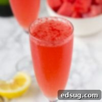 A refreshing watermelon bellini cocktail in a glass with a watermelon garnish