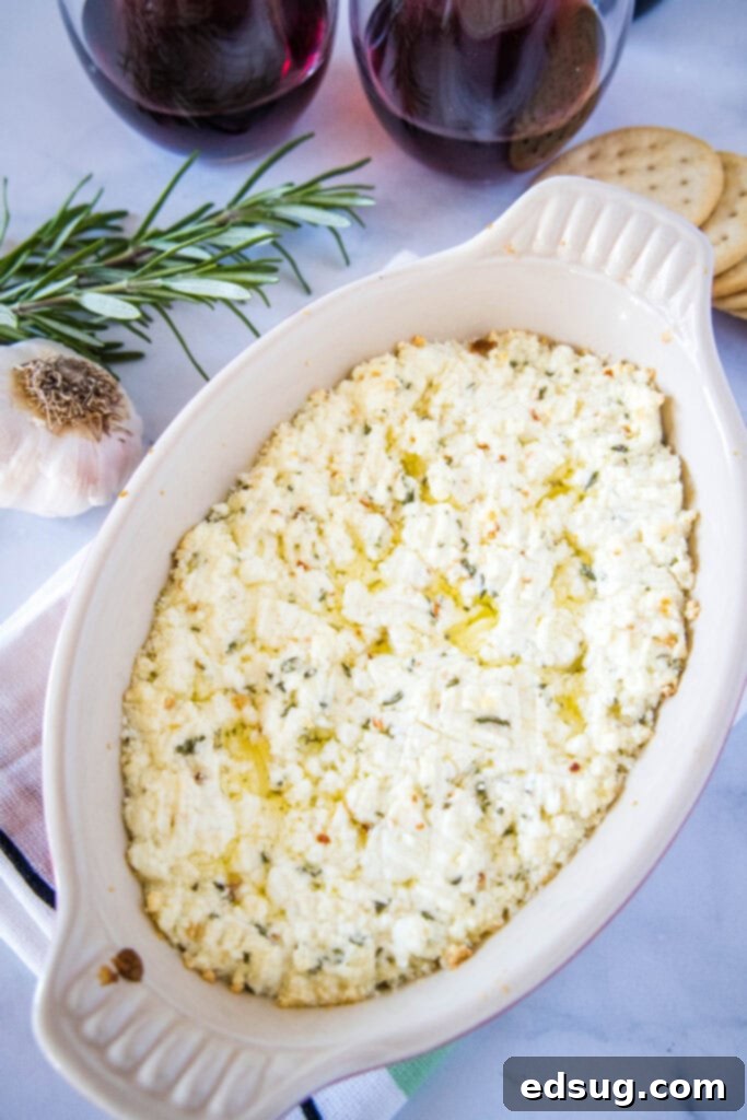 Warm, Tangy Goat Cheese Dip 5 looking down on a serving dish with goat cheese dip in it