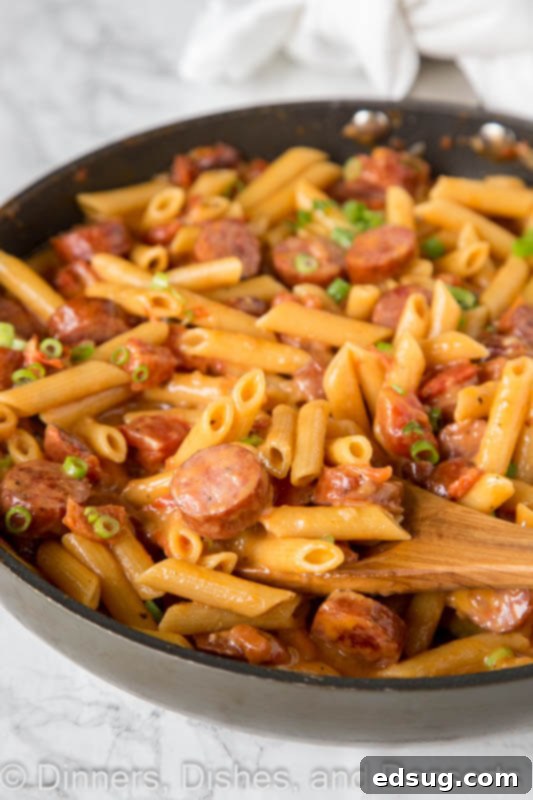 A dish is filled with food, with pasta and Sausage