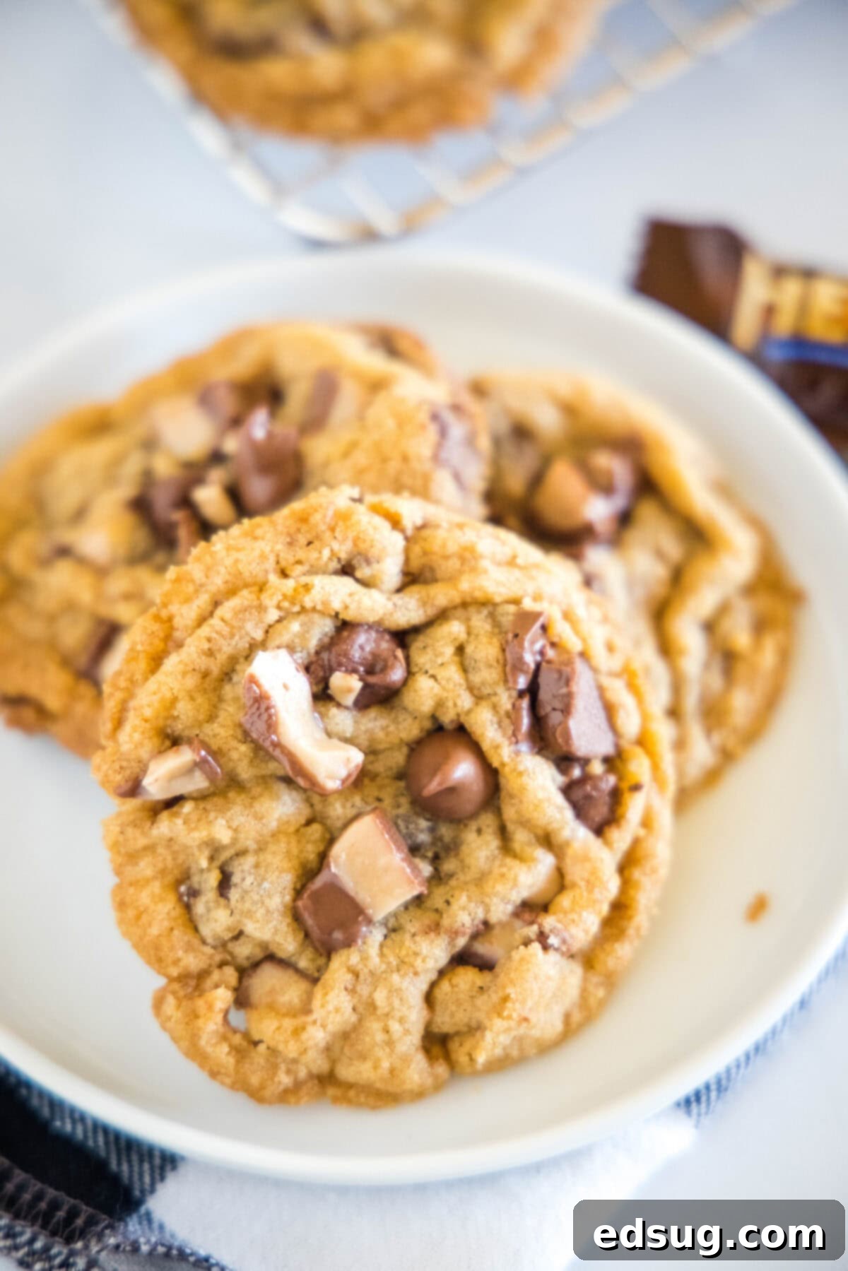 close up of toffee chocolate chip cookies on a plate