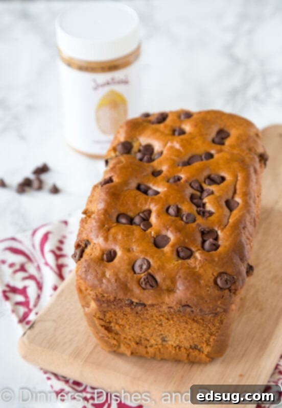 Peanut Butter Chocolate Chip Loaf 2 Delicious peanut butter chocolate chip bread loaf on a wooden cutting board, ready to be sliced