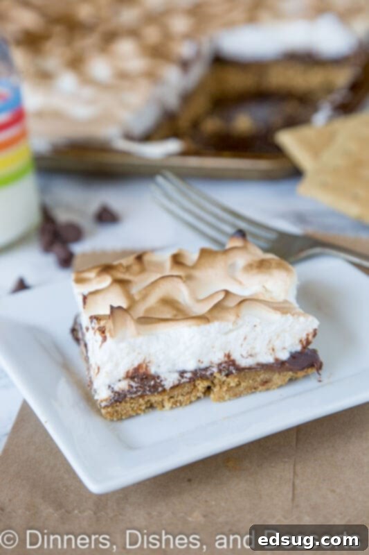 Sheet Pan S'mores Tart 4 Sheet pan s'mores tart on a baking sheet, freshly broiled with a perfectly golden meringue top.