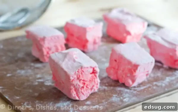 pink Kool-Aid marshmallows on cutting board