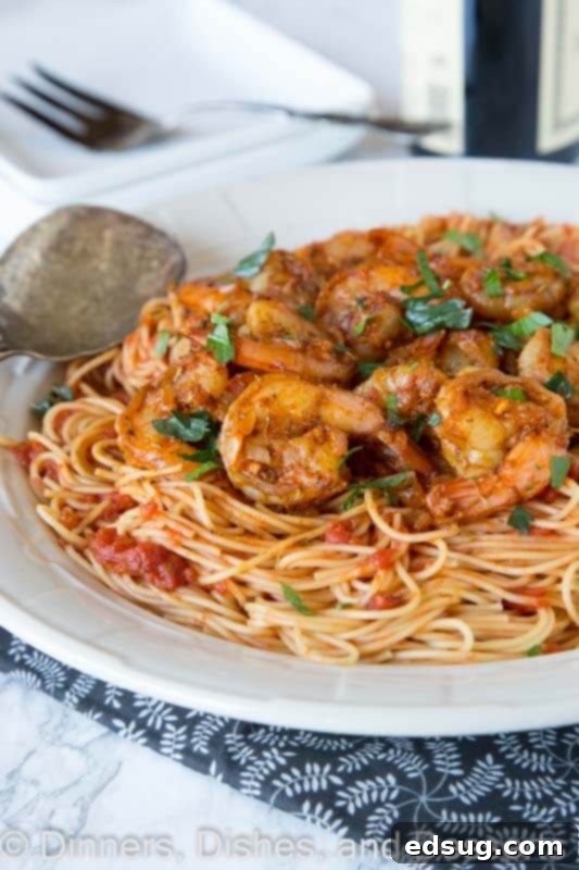 Cajun Blackened Shrimp Pasta 2 A vibrant plate of blackened shrimp pasta, showcasing perfectly cooked shrimp and a rich, spiced sauce.