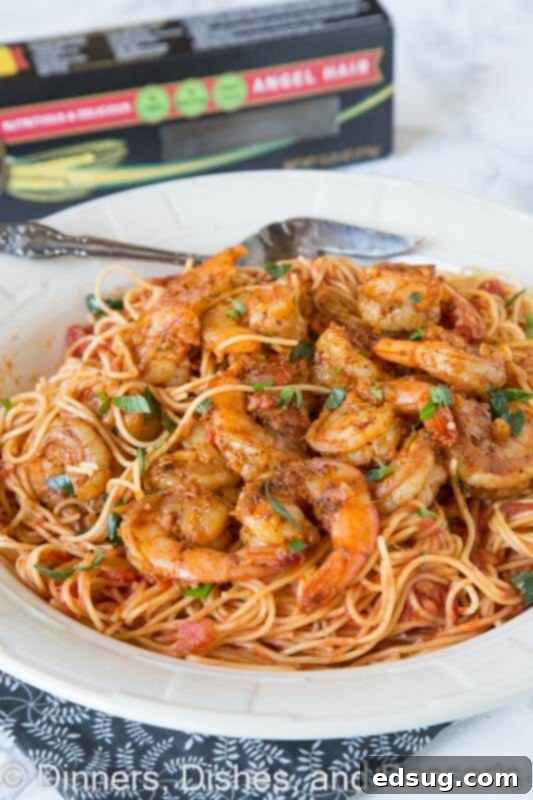 Cajun Blackened Shrimp Pasta 5 A close-up shot of freshly prepared blackened shrimp pasta in a bowl, garnished with herbs.