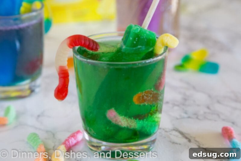 Primal Punch 3 Close-up of three glasses of monster juice, each with a different colored popsicle and various candy decorations.