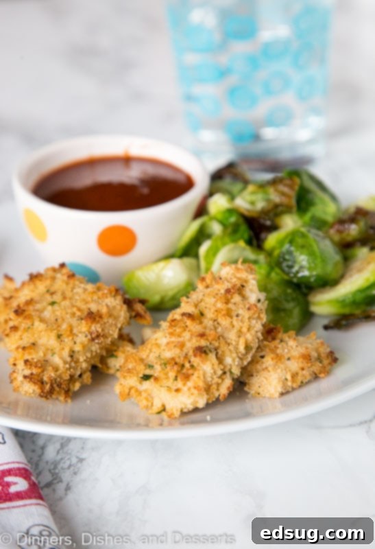 Adult Essentials 2 A plate of golden brown crispy homemade chicken nuggets with barbecue sauce on the side, garnished with fresh parsley.