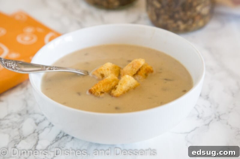 creamy mushroom soup in a bowl with a spoon