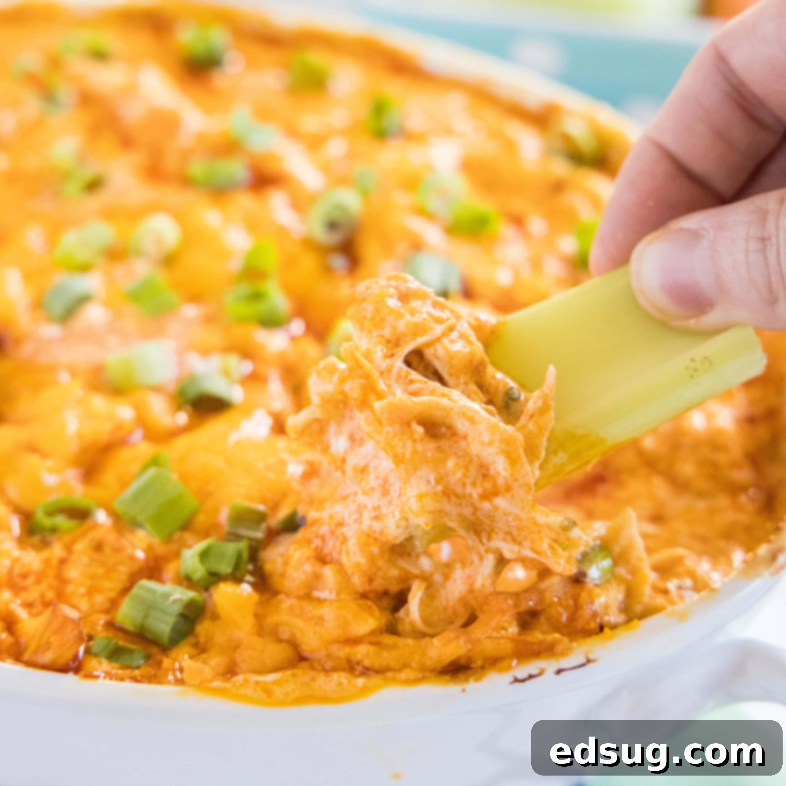 Kickoff Comfort Food 14 Close up of celery being dipped into creamy Instant Pot Buffalo Chicken Dip