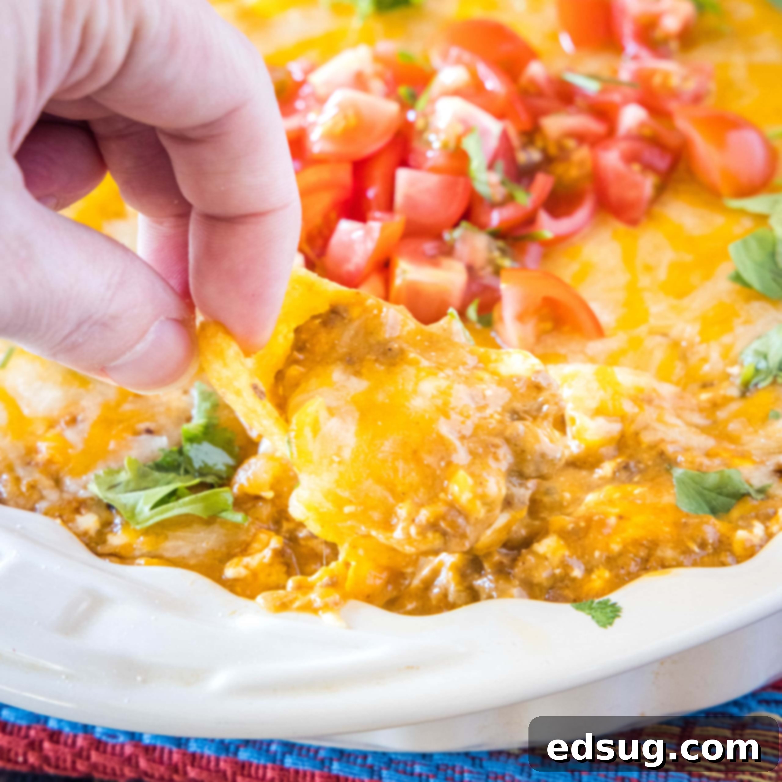 Kickoff Comfort Food 18 Close up of a chip scooping out warm Chili Cheese Dip